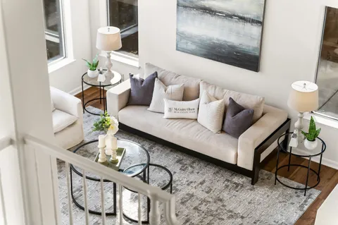 a living room with lots of furniture and a large window