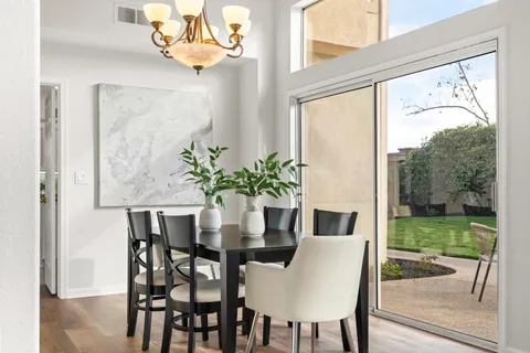 a kitchen with kitchen island granite countertop a sink a counter top space stainless steel appliances and cabinets