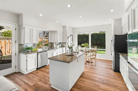a kitchen with stainless steel appliances granite countertop a sink and cabinets