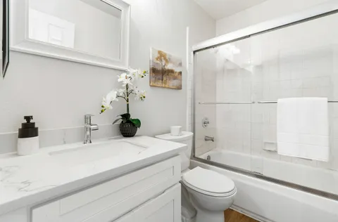 a bathroom with a toilet a sink and a mirror