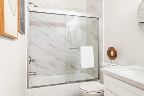 a spacious bathroom with a double vanity sink and a mirror