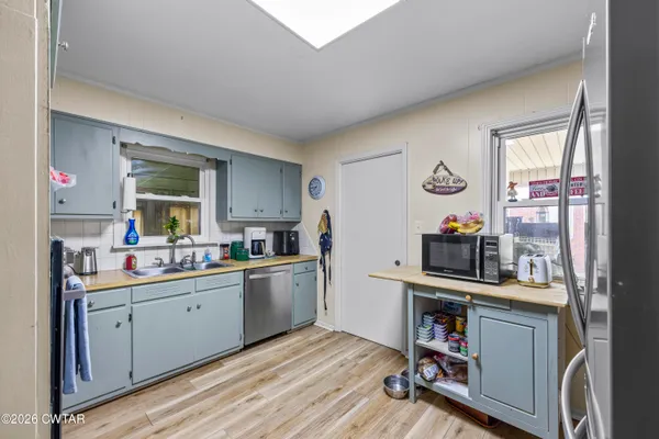 a kitchen with a sink cabinets and window