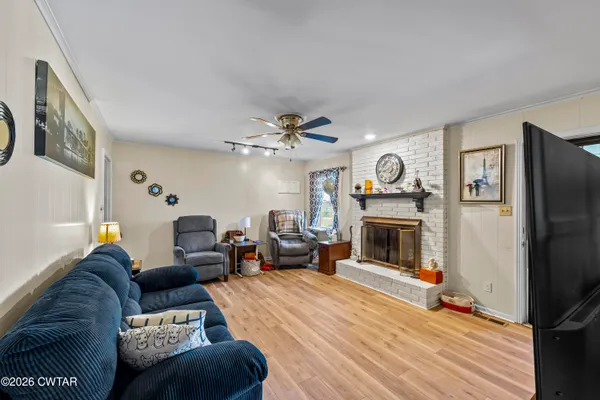 a living room with furniture a flat screen tv and a fireplace