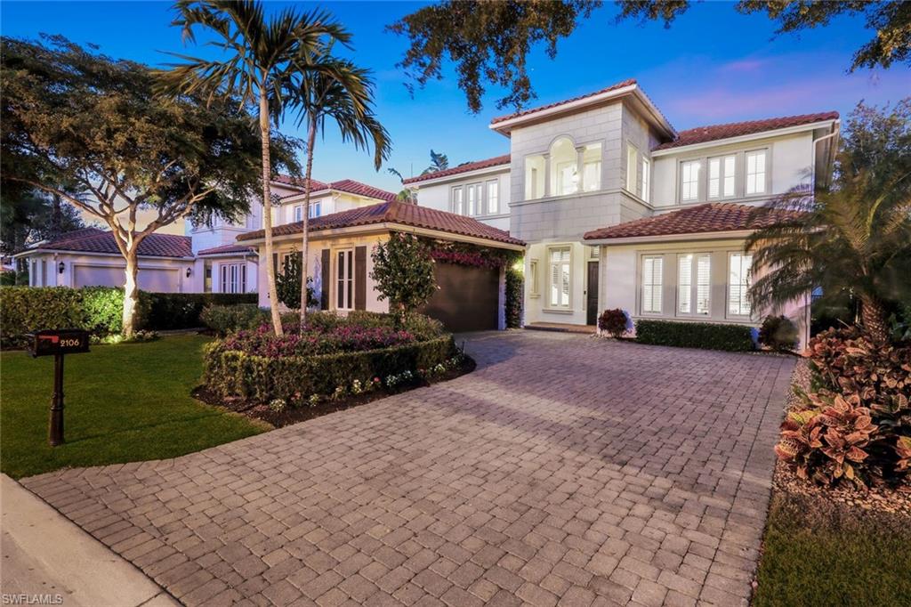 2106 Modena Court Naples, FL 34105 - Photo 2 of 42 front view of a house with a yard