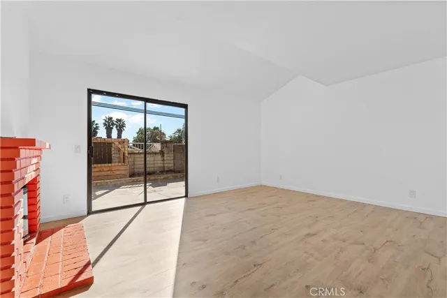an empty room with sliding glass door