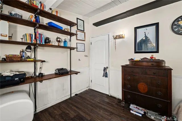 a view of a workspace with furniture and a book shelf