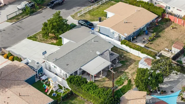 an aerial view of multiple houses with yard