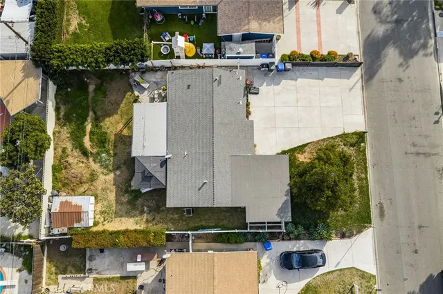 a aerial view of a house with swimming pool and large trees