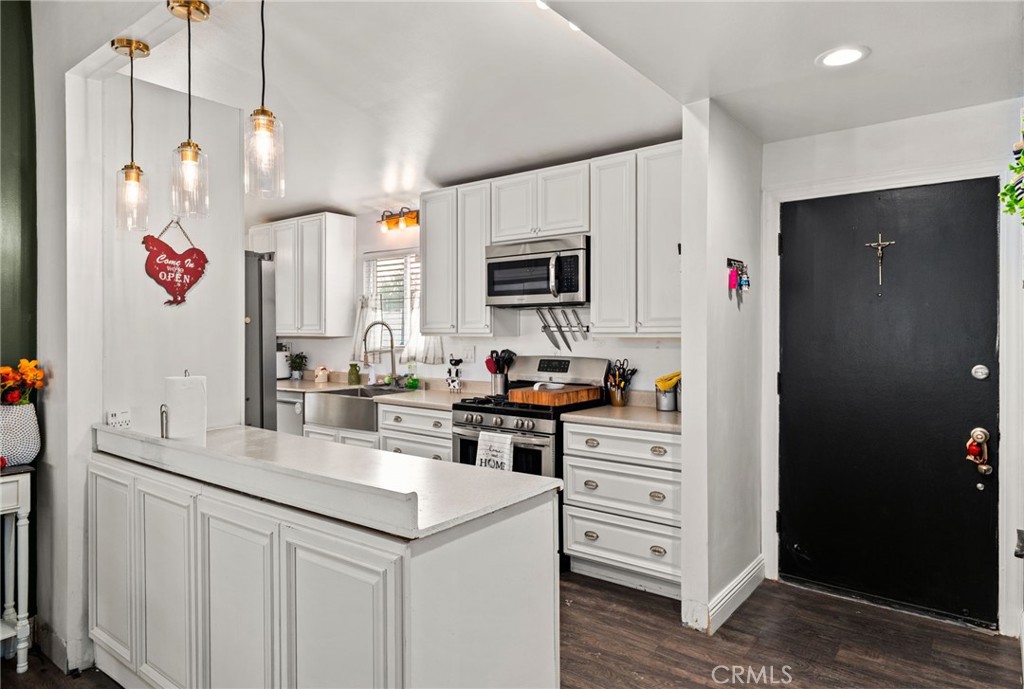 5208 North Leaf Azusa, CA 91702 - Photo 7 of 34 a kitchen with granite countertop a sink cabinets and stainless steel appliances