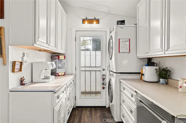 a kitchen with refrigerator and cabinets