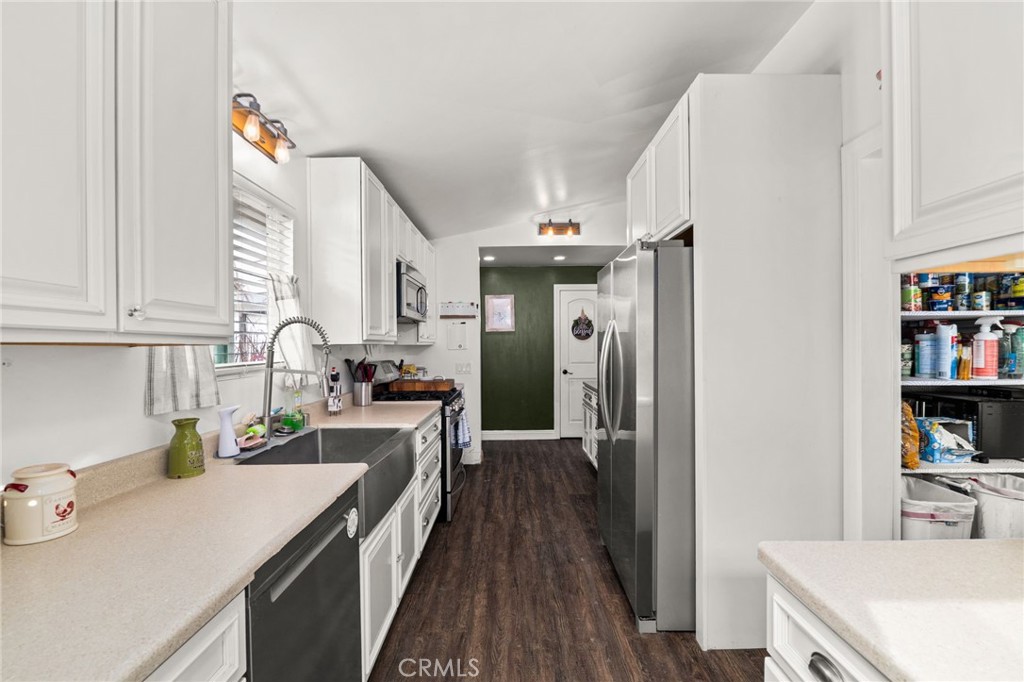 5208 North Leaf Azusa, CA 91702 - Photo 10 of 34 a kitchen that has a lot of cabinets a sink and wooden floor