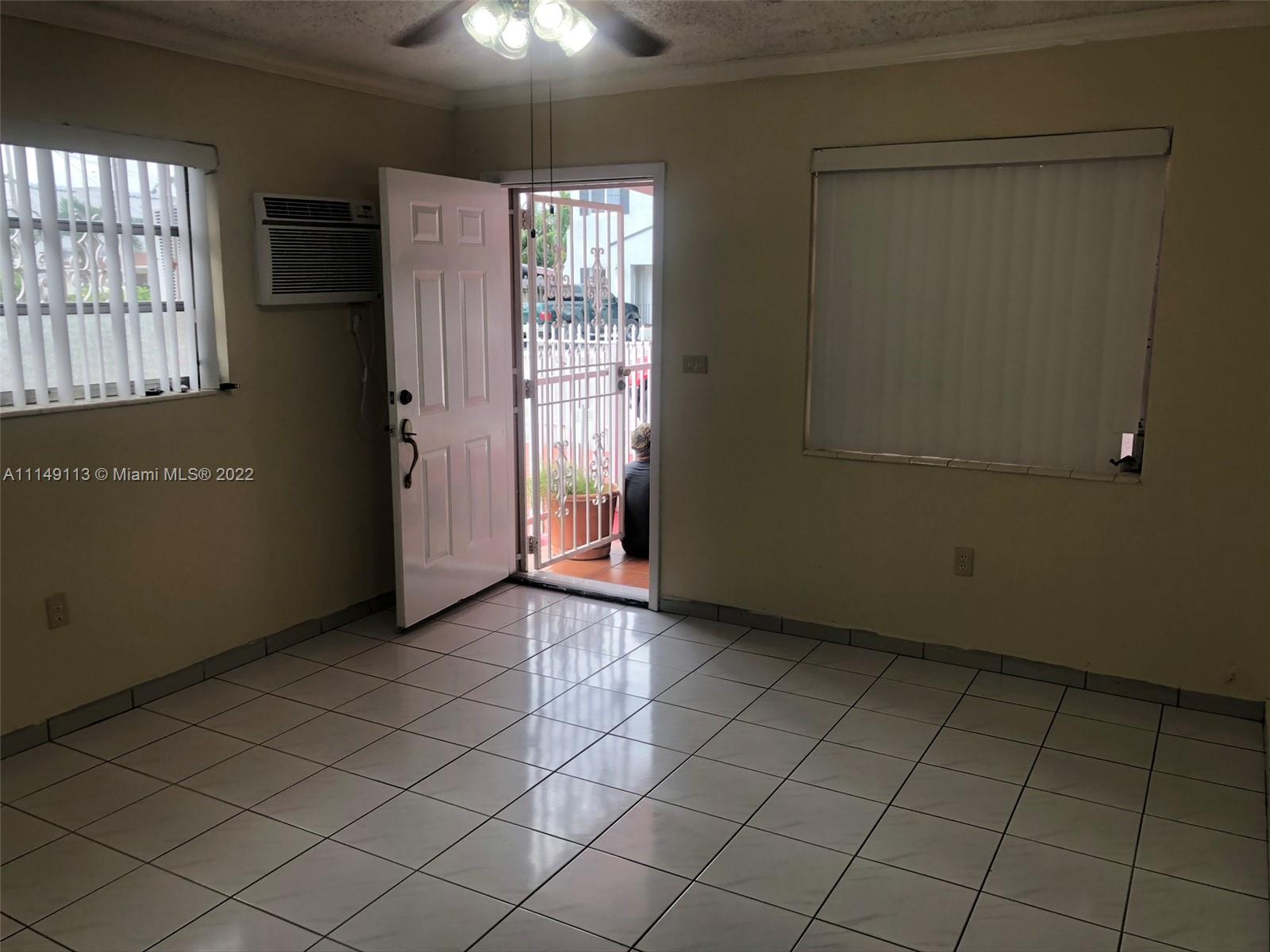 1709 Northwest 22nd Court Miami, FL 33125 - Photo 5 of 7 an empty room with windows