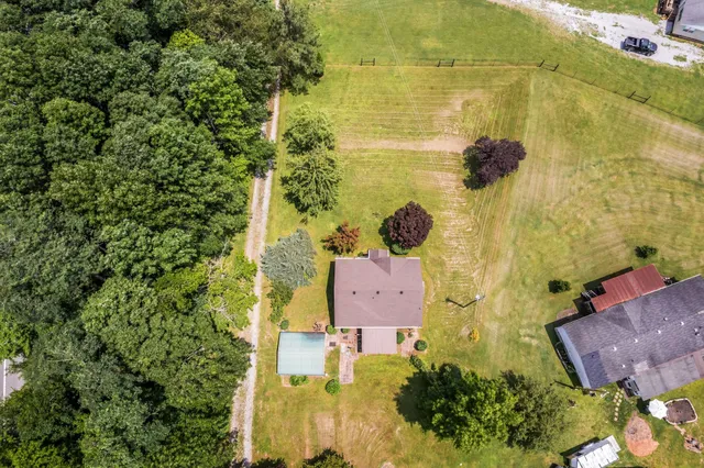 an aerial view of residential house with parking