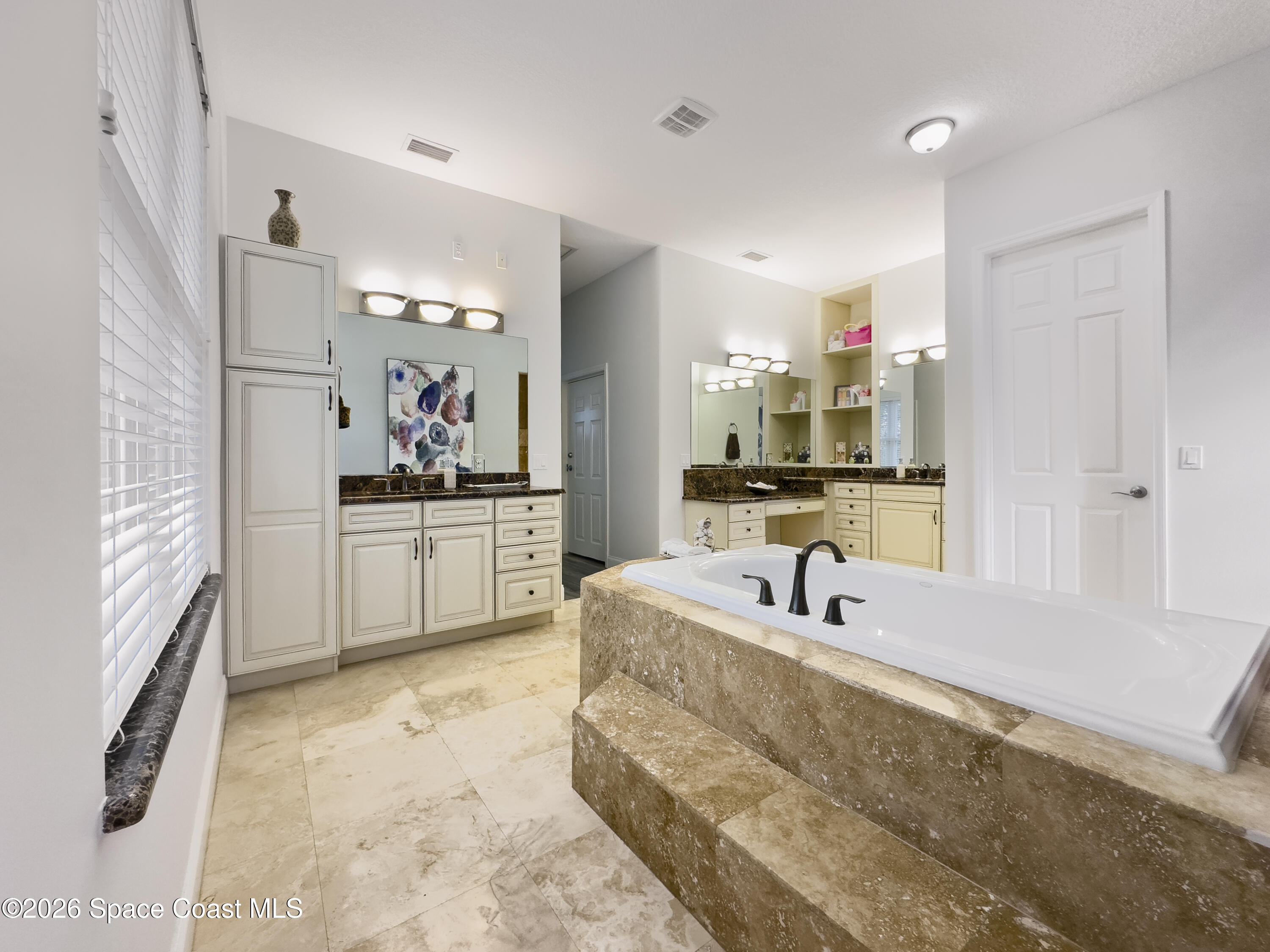 4762 Blossom Ridge Place Grant, FL 32949 - Photo 18 of 42 a bathroom with a double vanity sink tub and mirror