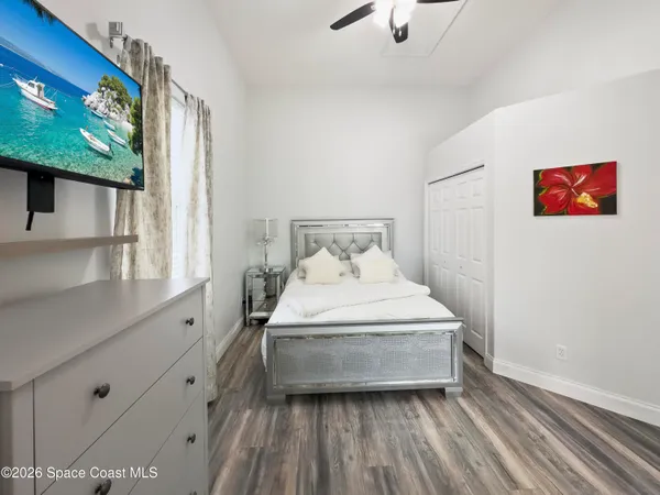 a bedroom with a large bed and a window