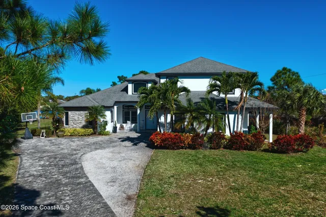 a view of a garden with a bench in the background