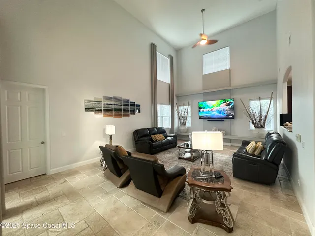 a bedroom with a bed and a flat tv screen on dresser