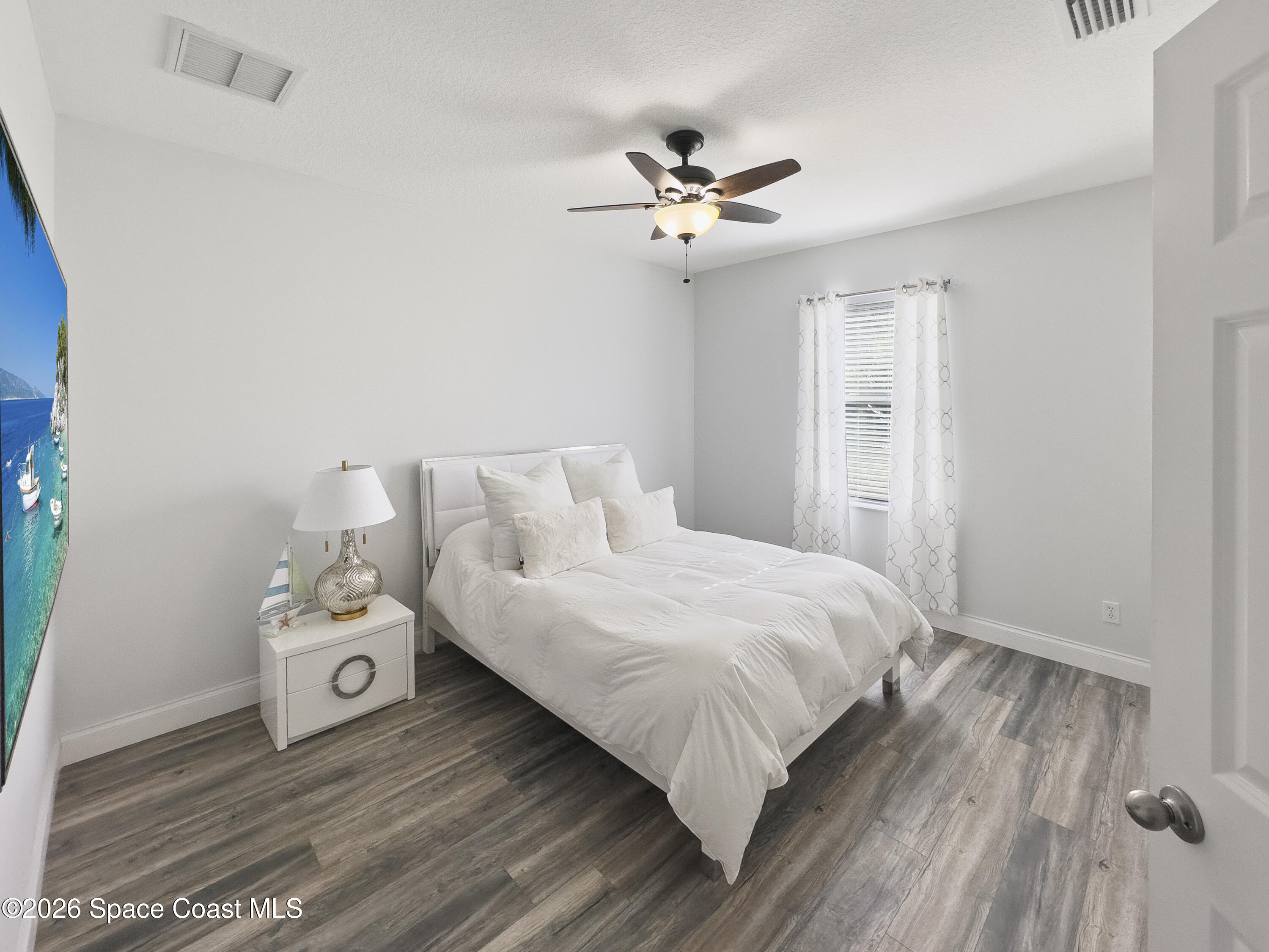 4762 Blossom Ridge Place Grant, FL 32949 - Photo 27 of 42 a bedroom with a bed and wooden floor