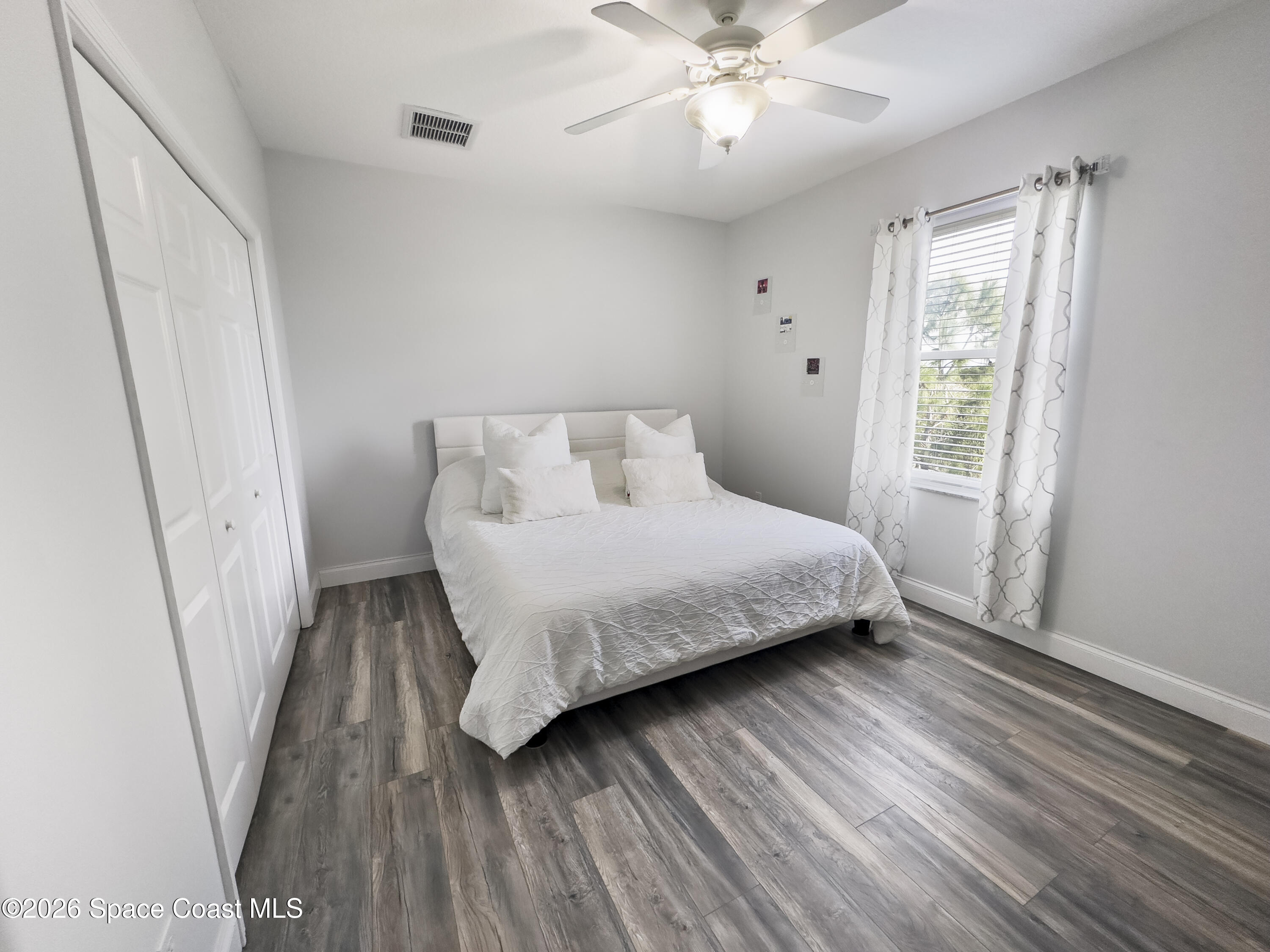 4762 Blossom Ridge Place Grant, FL 32949 - Photo 29 of 42 a bedroom with a large bed and a window