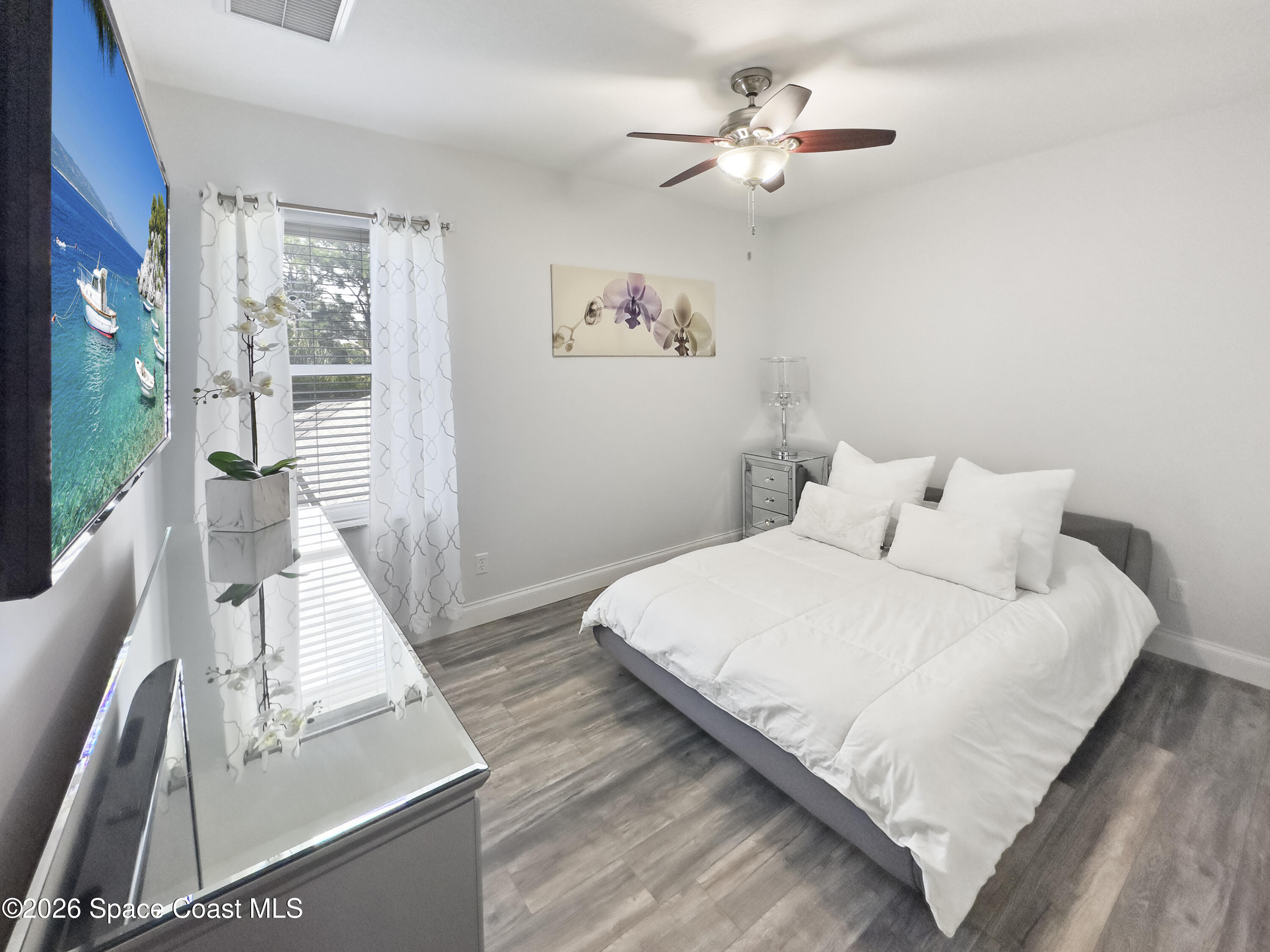 4762 Blossom Ridge Place Grant, FL 32949 - Photo 30 of 42 a spacious bedroom with a bed and a large window
