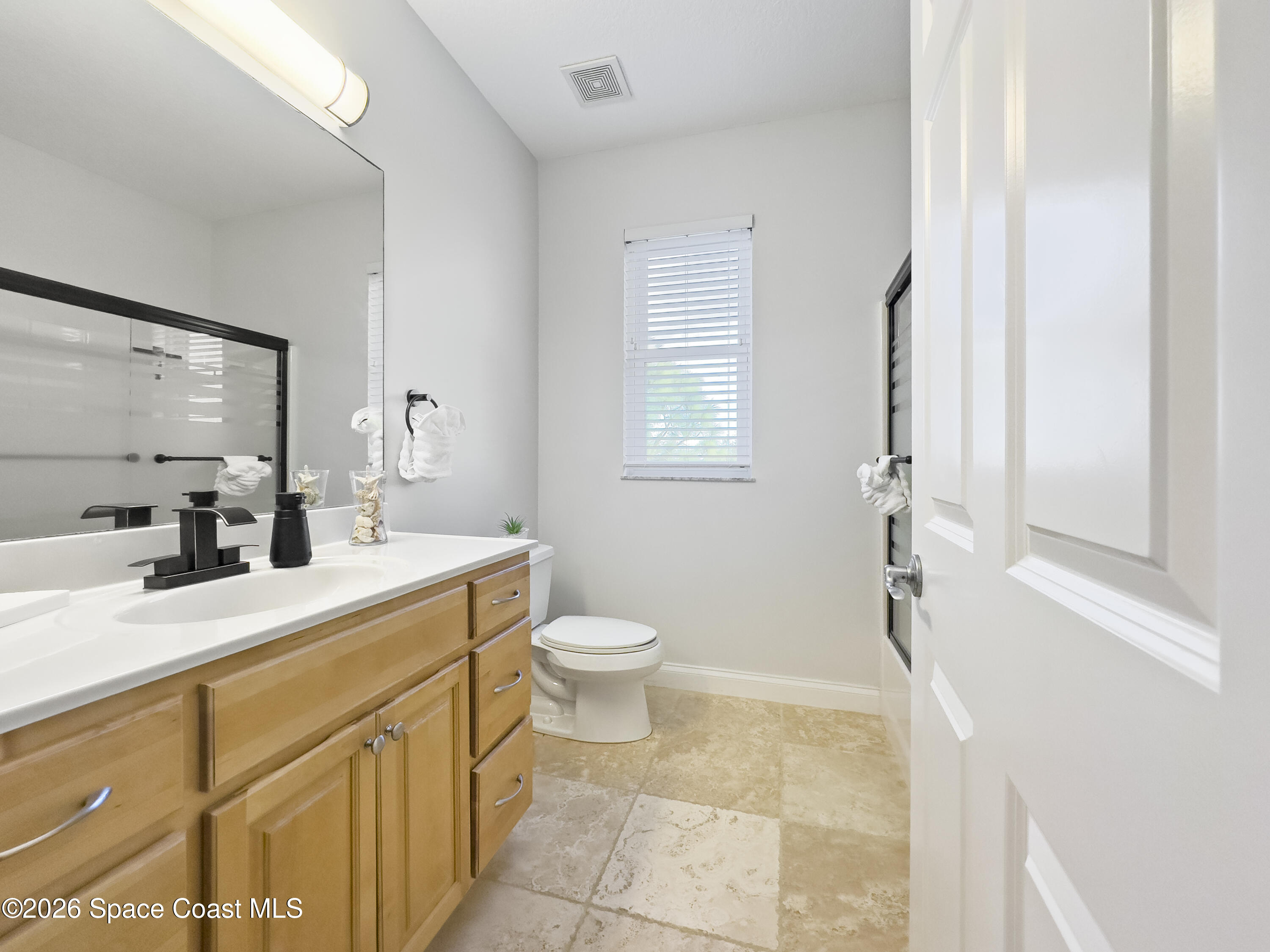 4762 Blossom Ridge Place Grant, FL 32949 - Photo 31 of 42 a bathroom with a sink a toilet and a mirror