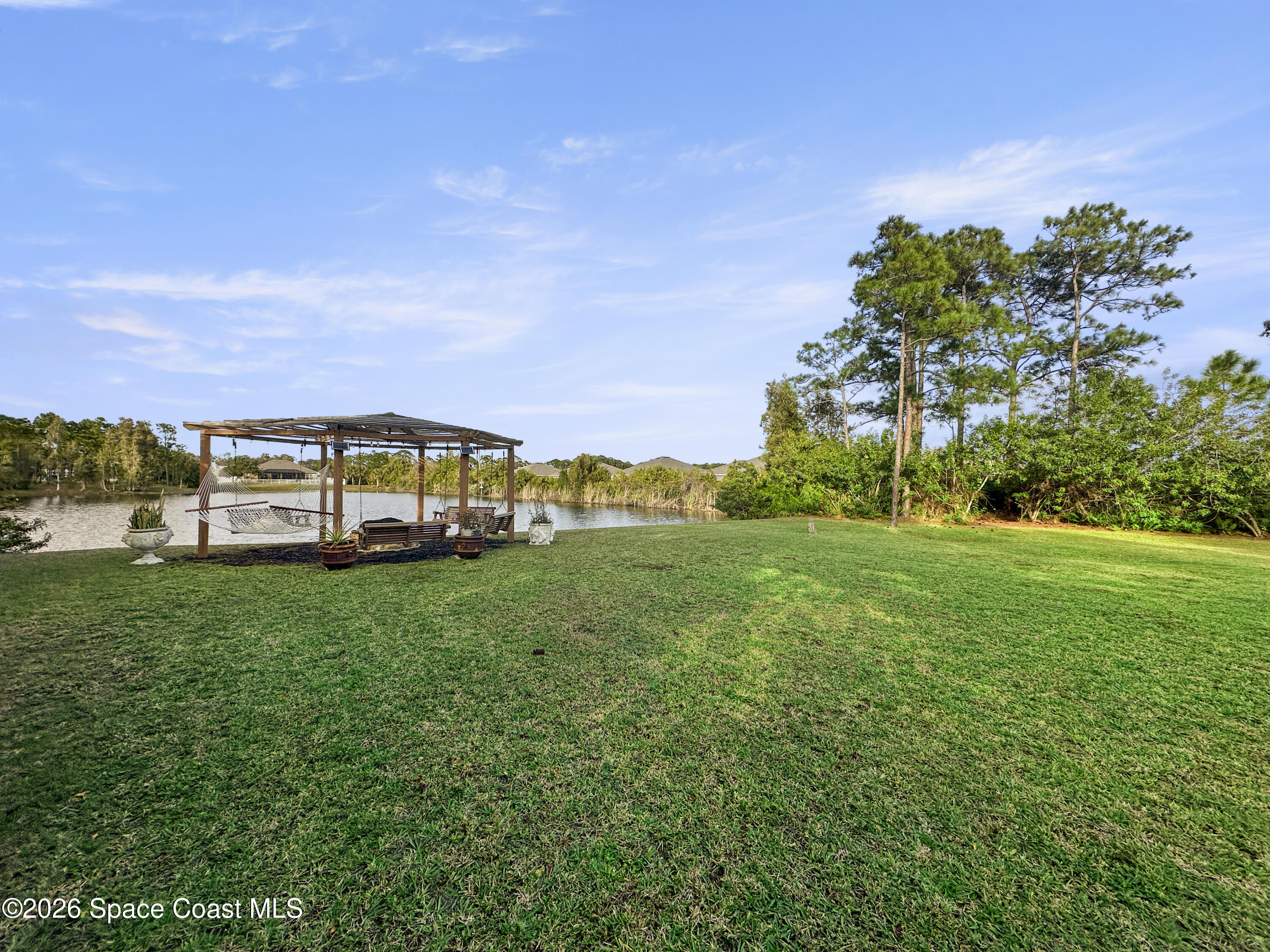 4762 Blossom Ridge Place Grant, FL 32949 - Photo 39 of 42 a view of a house with a big yard