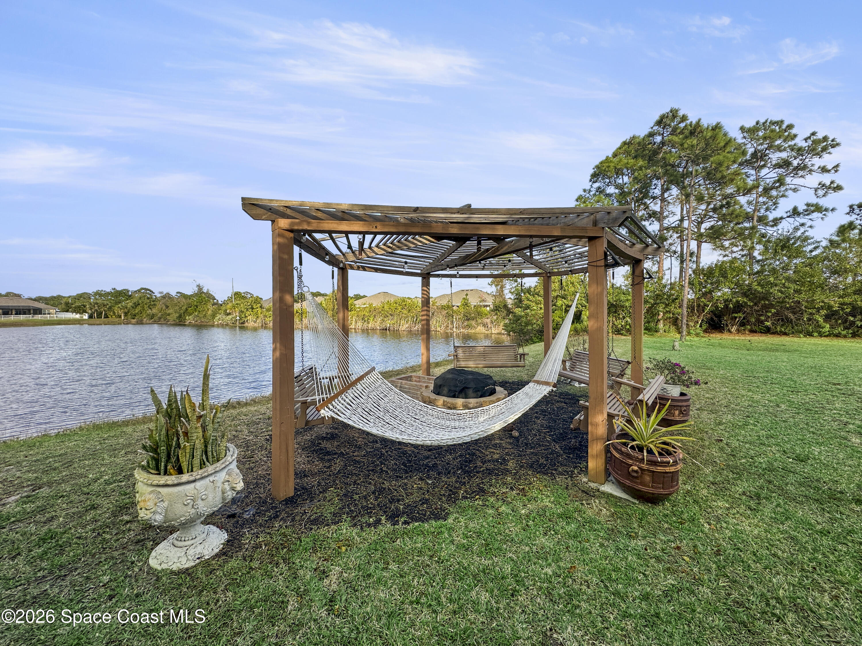 4762 Blossom Ridge Place Grant, FL 32949 - Photo 40 of 42 a backyard of a house with table and chairs