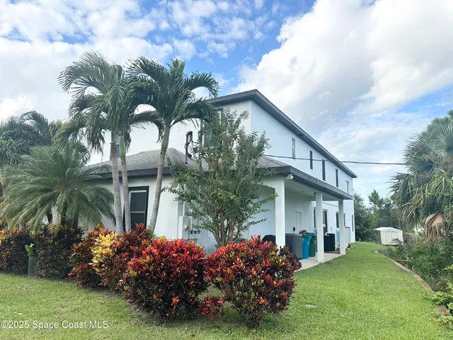 a view of a dining room with furniture a rug and wooden floor