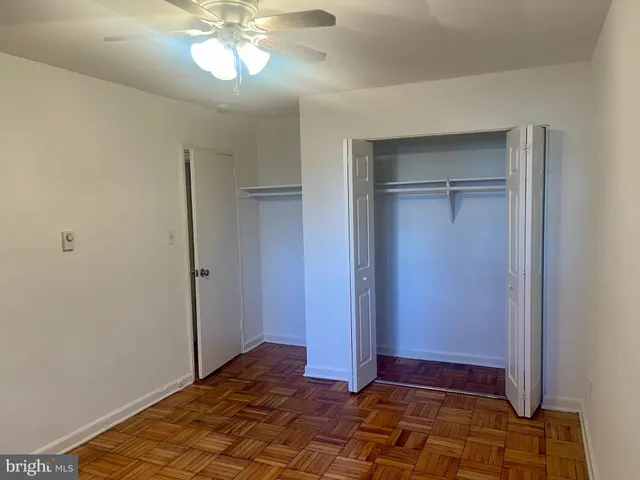 a view of a room with wooden floor and fan