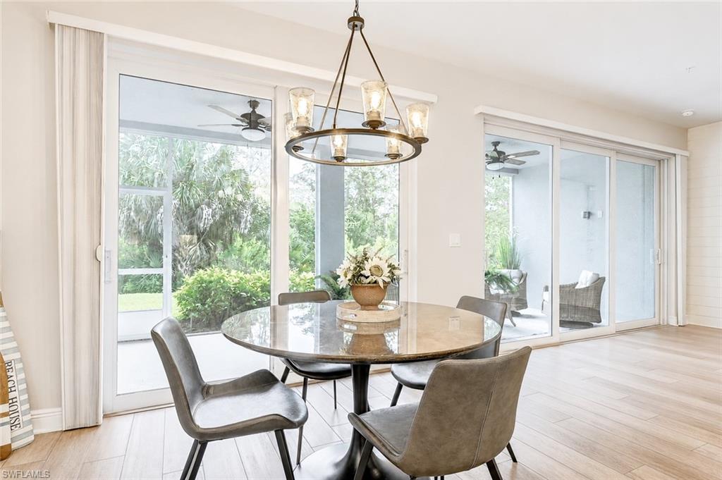 2620 Seychelles Circle, Unit 1302 Naples, FL 34112 - Photo 10 of 43 a dining room with furniture window and wooden floor