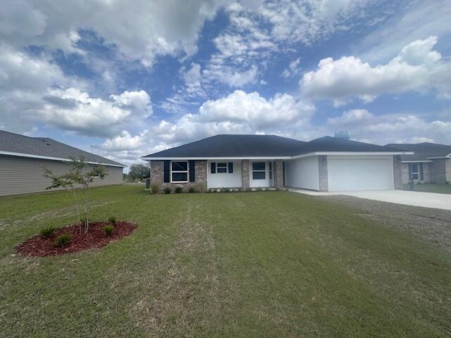 6118 Buckshot Drive Crestview, FL 32539 - Photo 1 of 22 a front view of a house with a garden