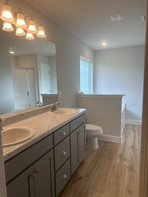 6118 Buckshot Drive Crestview, FL 32539 - Photo 13 of 22 a bathroom with a granite countertop sink a toilet and a mirror