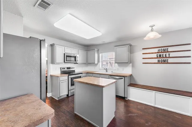 a large kitchen with a sink and large window