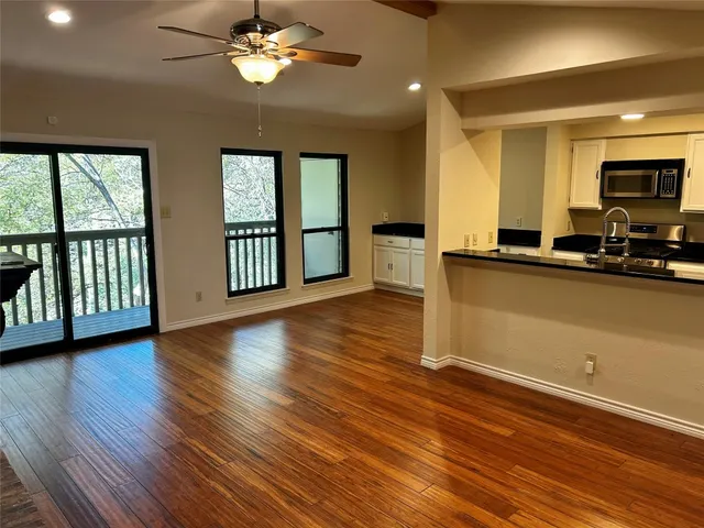 a view of a livingroom with furniture a ceiling fan and window