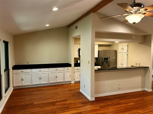 a view of a kitchen with wooden floor