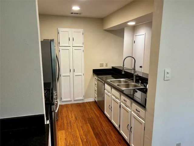 a kitchen with stainless steel appliances granite countertop a stove and a refrigerator