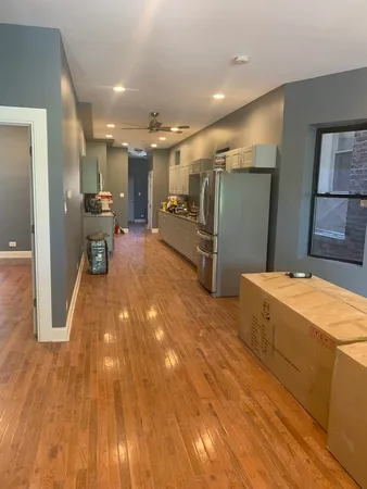 a very nice looking room with a large kitchen counter space and stainless steel appliances