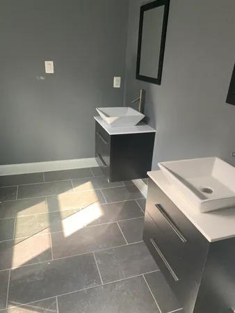 a bathroom with a sink toilet and mirror