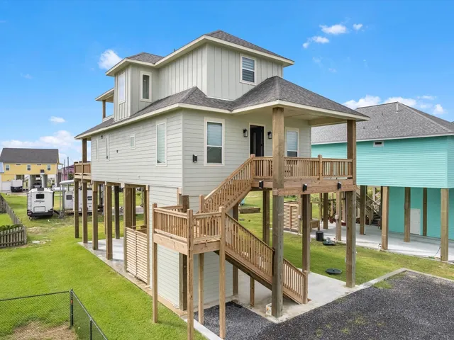 a view of a house with wooden fence