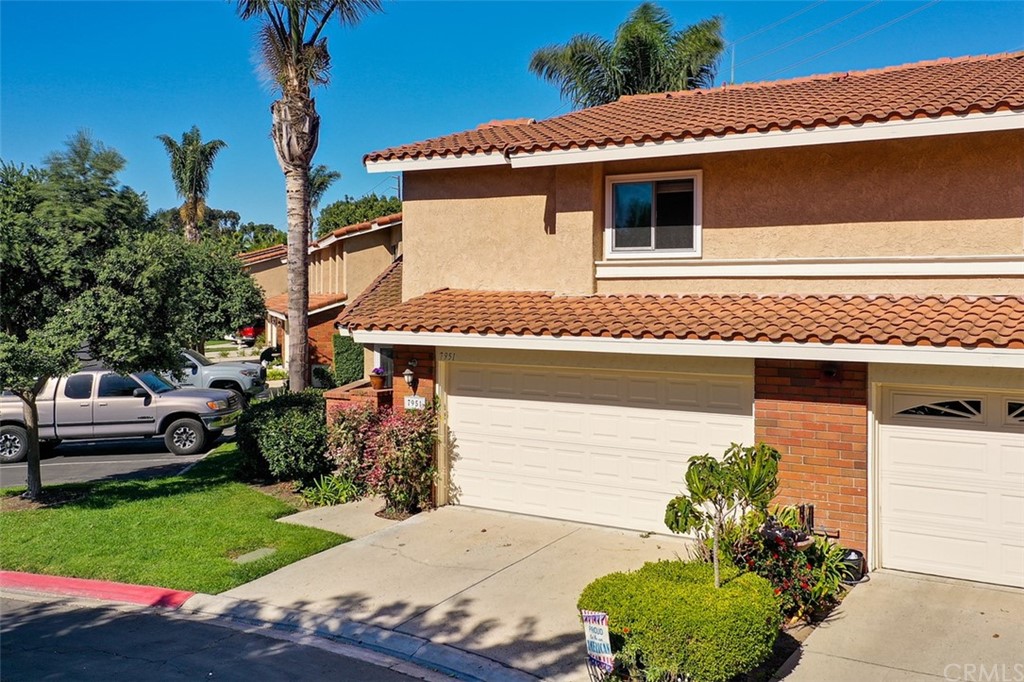 7951 Waterfall Circle Huntington Beach, CA 92648 - Photo 2 of 40 a front view of a house with a garden
