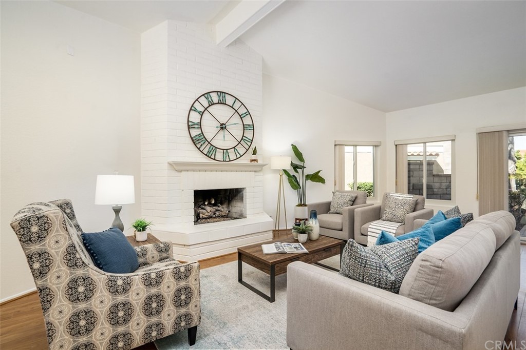 7951 Waterfall Circle Huntington Beach, CA 92648 - Photo 13 of 40 a living room with furniture a fireplace and a large window