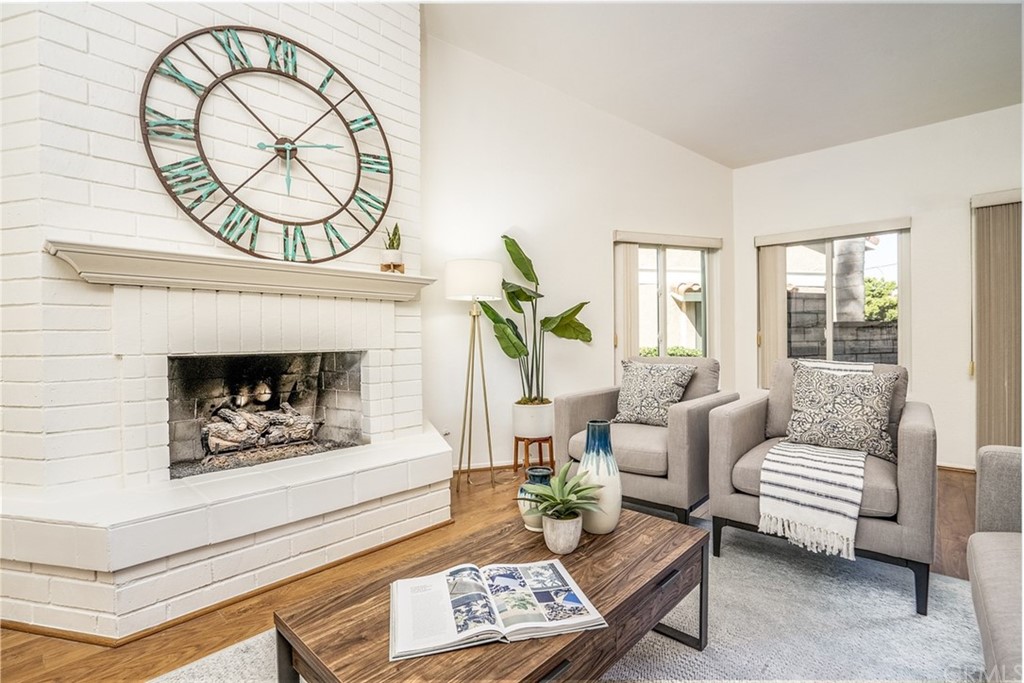 7951 Waterfall Circle Huntington Beach, CA 92648 - Photo 14 of 40 a living room with furniture a fireplace and a potted plant
