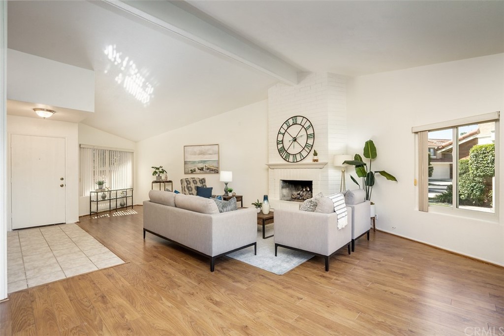 7951 Waterfall Circle Huntington Beach, CA 92648 - Photo 15 of 40 a living room with furniture a fireplace and a window