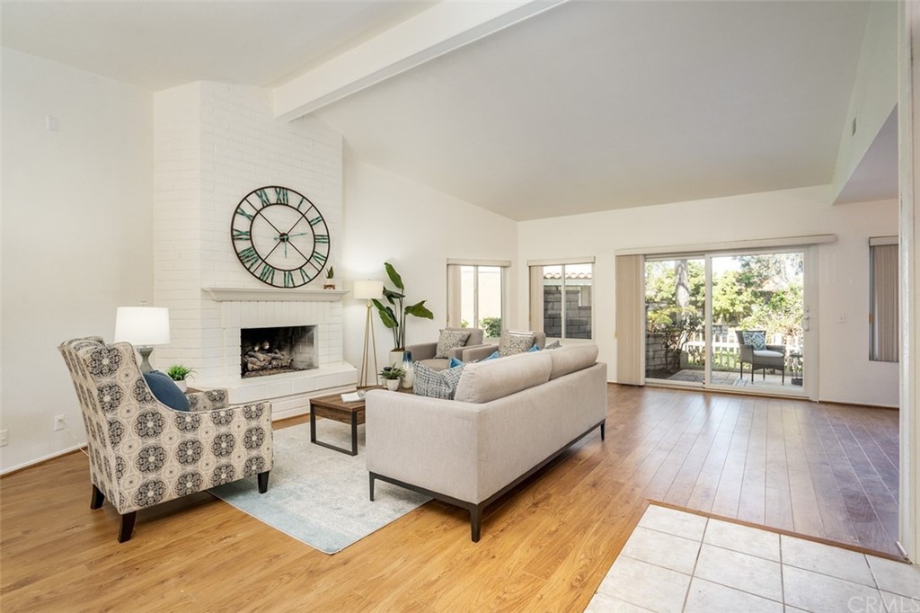 7951 Waterfall Circle Huntington Beach, CA 92648 - Photo 16 of 40 a living room with furniture a fireplace and a floor to ceiling window
