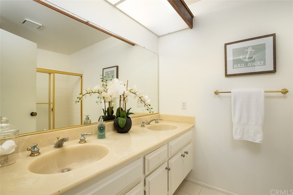 7951 Waterfall Circle Huntington Beach, CA 92648 - Photo 19 of 40 a bathroom with a sink and a mirror