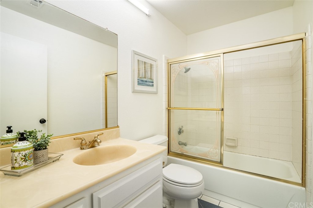 7951 Waterfall Circle Huntington Beach, CA 92648 - Photo 21 of 40 a bathroom with a shower sink vanity mirror and toilet