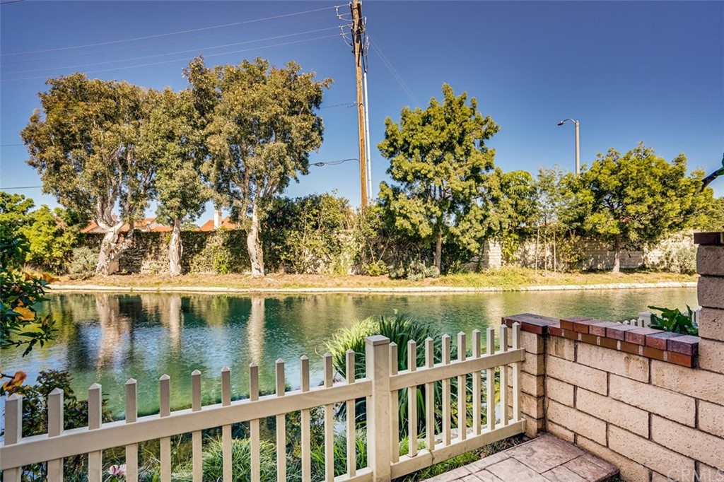7951 Waterfall Circle Huntington Beach, CA 92648 - Photo 29 of 40 a view of a lake with a bench in front of it
