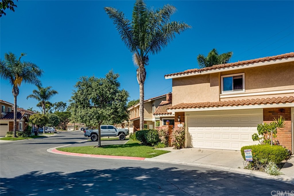 7951 Waterfall Circle Huntington Beach, CA 92648 - Photo 4 of 40 a front view of a house with a yard and garage