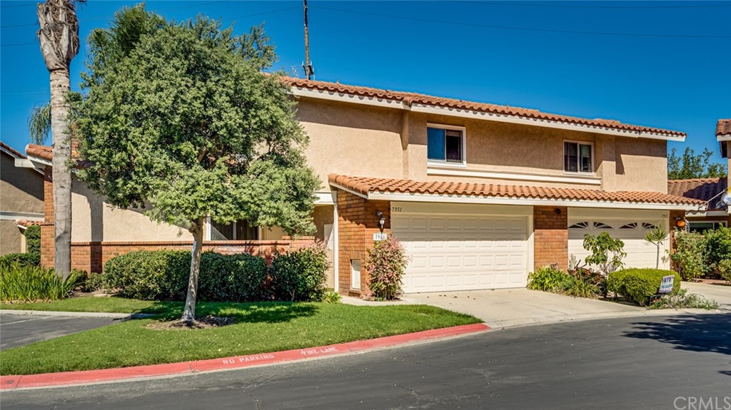 7951 Waterfall Circle Huntington Beach, CA 92648 - Photo 5 of 40 a front view of a house with a yard and garage