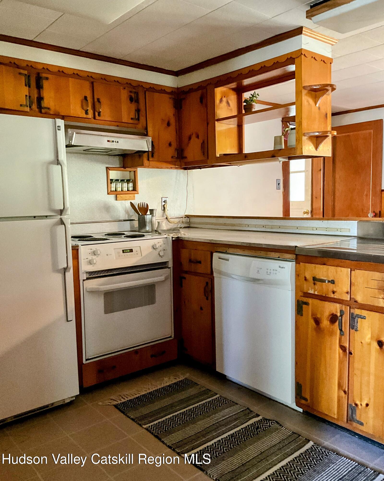 729 Springtown Road Tillson, NY 12486 - Photo 19 of 52 a kitchen with a stove and a refrigerator